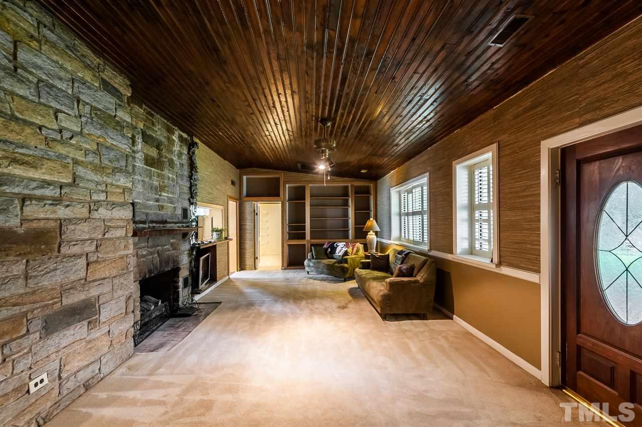 4308 Ryegate Drive Raleigh, NC 27604 - Photo 5 of 23 a living room with furniture a fireplace and a flat screen tv