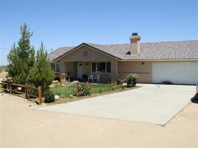 6632 Solano Road Phelan, CA 92371 - Photo 1 of 1 a front view of a house with a garden