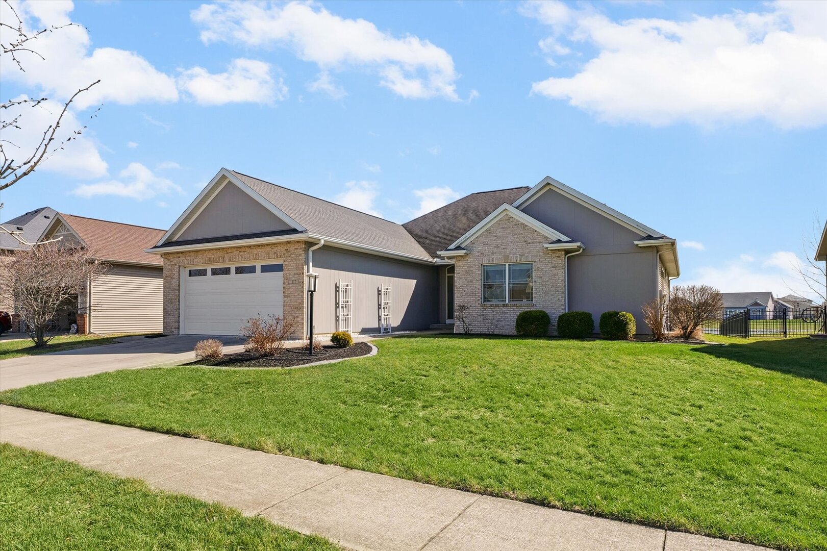 1117 Declaration Drive Savoy, IL 61874 - Photo 1 of 56 a front view of a house with a yard and garage