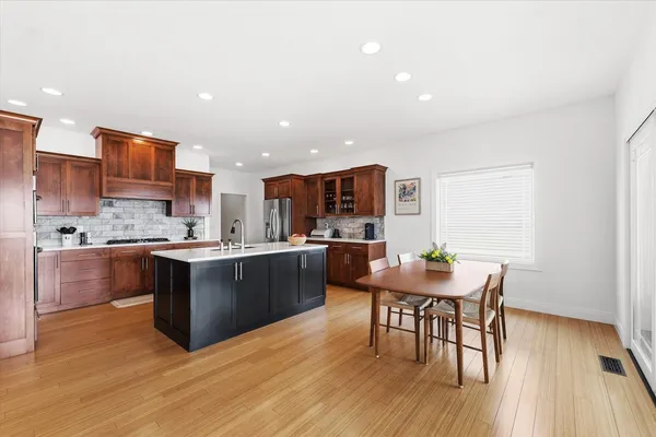 a large kitchen with a table and chairs