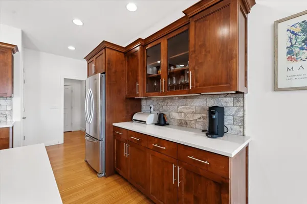 a kitchen with stainless steel appliances a table and a refrigerator