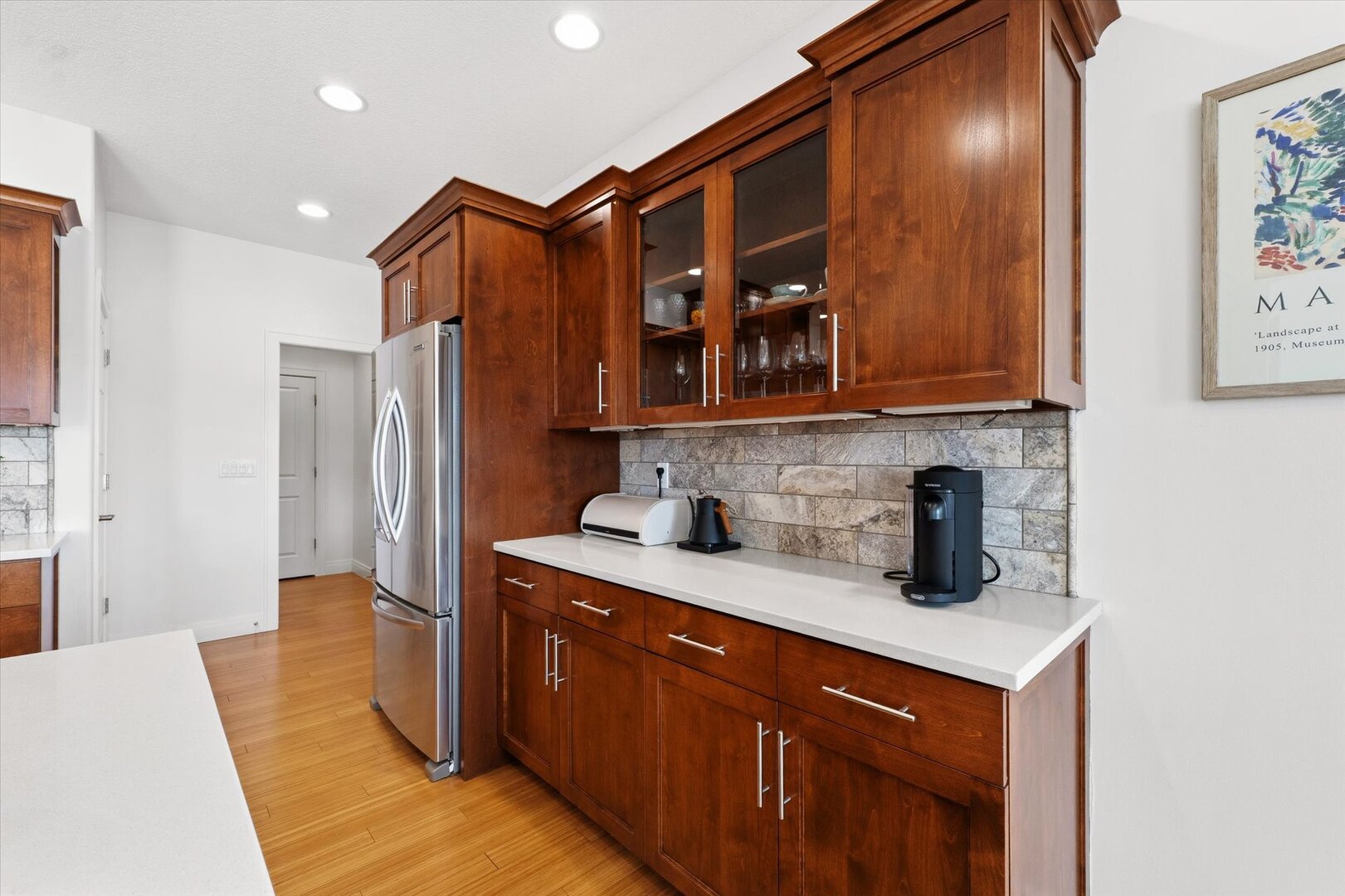 1117 Declaration Drive Savoy, IL 61874 - Photo 15 of 56 a kitchen with stainless steel appliances granite countertop a sink a refrigerator and wooden cabinets
