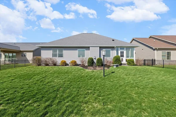 a front view of a house with a garden and yard