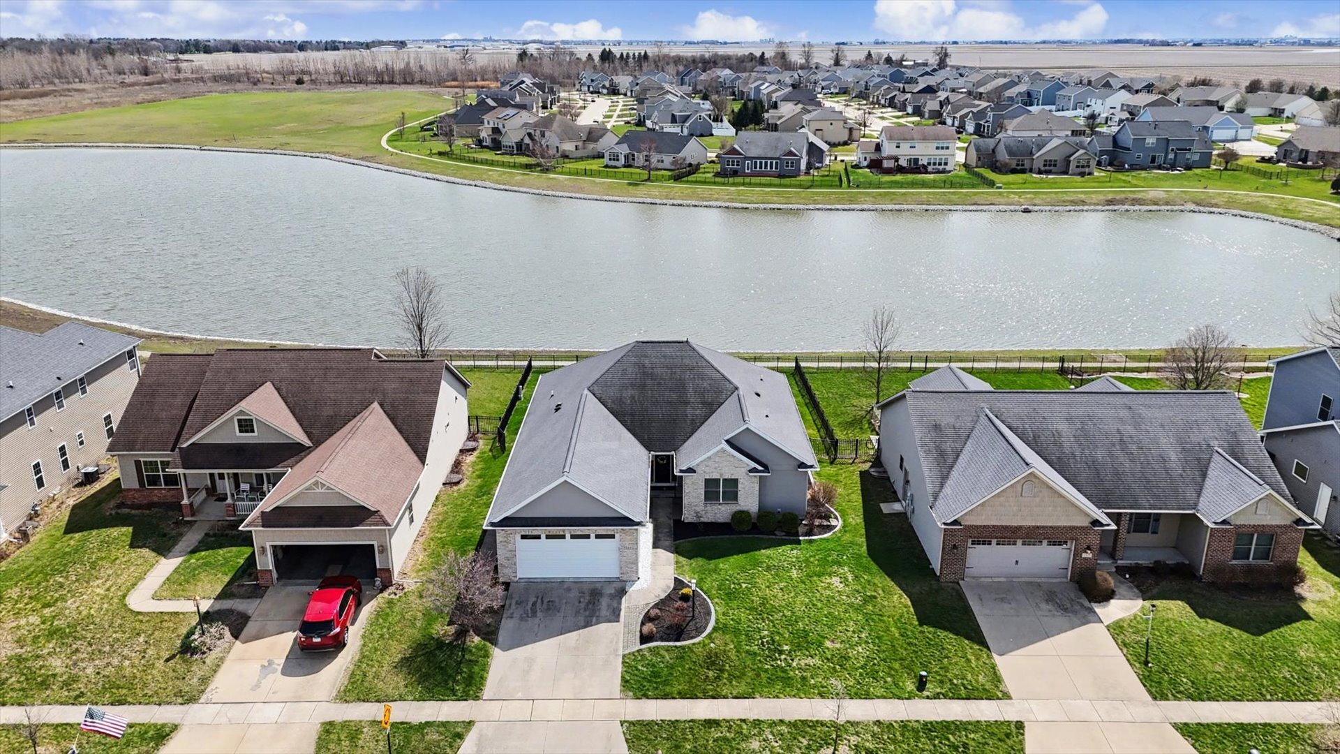 1117 Declaration Drive Savoy, IL 61874 - Photo 45 of 56 an aerial view of a house with a swimming pool patio and lake view
