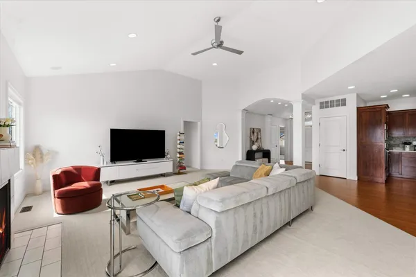 a living room with furniture a rug and a fireplace
