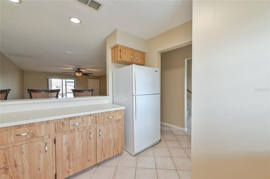 11001 Southeast Sunset Harbor Road, Unit H52 Summerfield, FL 34491 - Photo 23 of 31 a kitchen with granite countertop a refrigerator and a sink