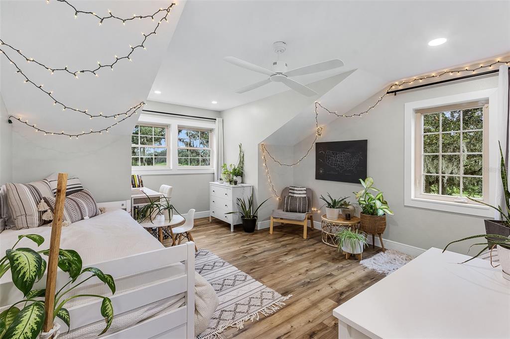 11720 Darsey Road Parrish, FL 34219 - Photo 34 of 60 a living room with furniture floor to ceiling window and a flat screen tv