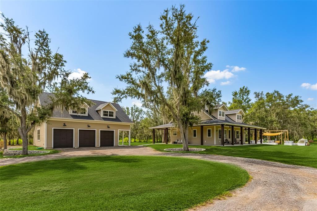 11720 Darsey Road Parrish, FL 34219 - Photo 4 of 60 a front view of a house with a garden