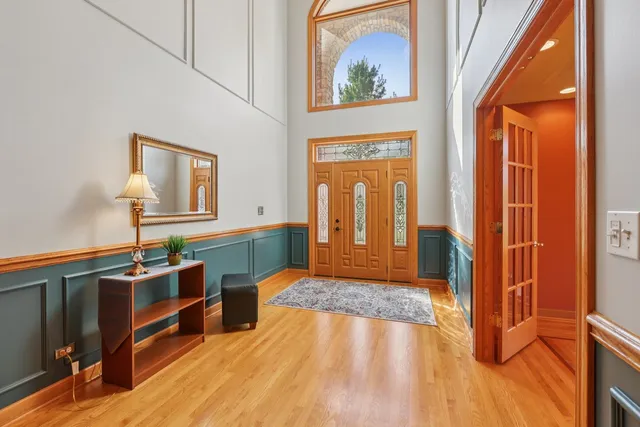 an open kitchen with stainless steel appliances granite countertop a refrigerator dining table and chairs with wooden floor