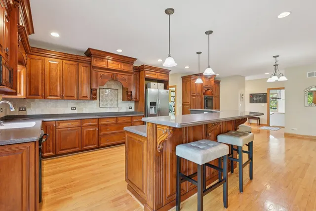 a bathroom with a granite countertop sink toilet a mirror a shower and a bathtub