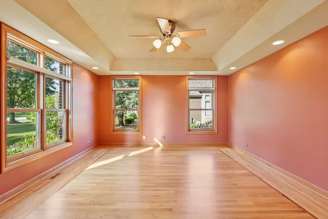 a view of a dining room with furniture large windows and wooden floor