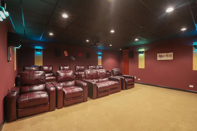 a dining room with large wooden floor and windows