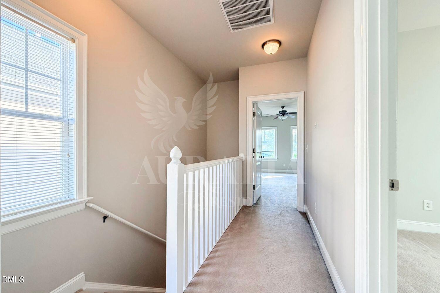 7754 ACC Boulevard Raleigh, NC 27617 - Photo 18 of 41 a view of a hallway with a window and a livingroom