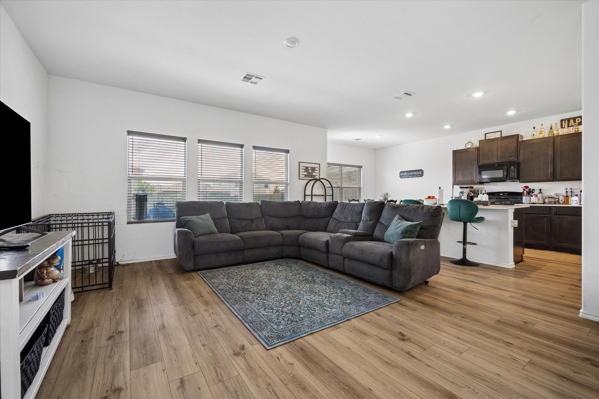 217 Canley Loop Hutto, TX 78634 - Photo 11 of 36 An inviting open concept living space features abundant natural light and rich wood flooring.