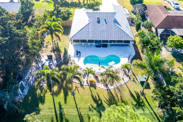a aerial view of a house with swimming pool and garden space