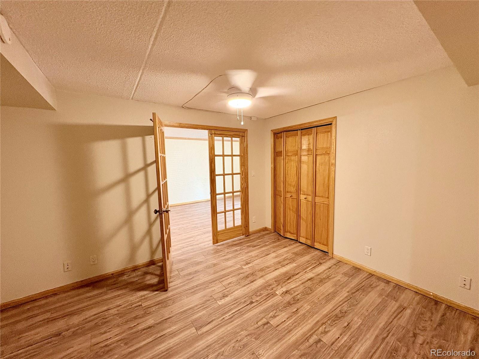 805 29th Street, Unit 253 Boulder, CO 80303 - Photo 13 of 32 an empty room with wooden floor and windows