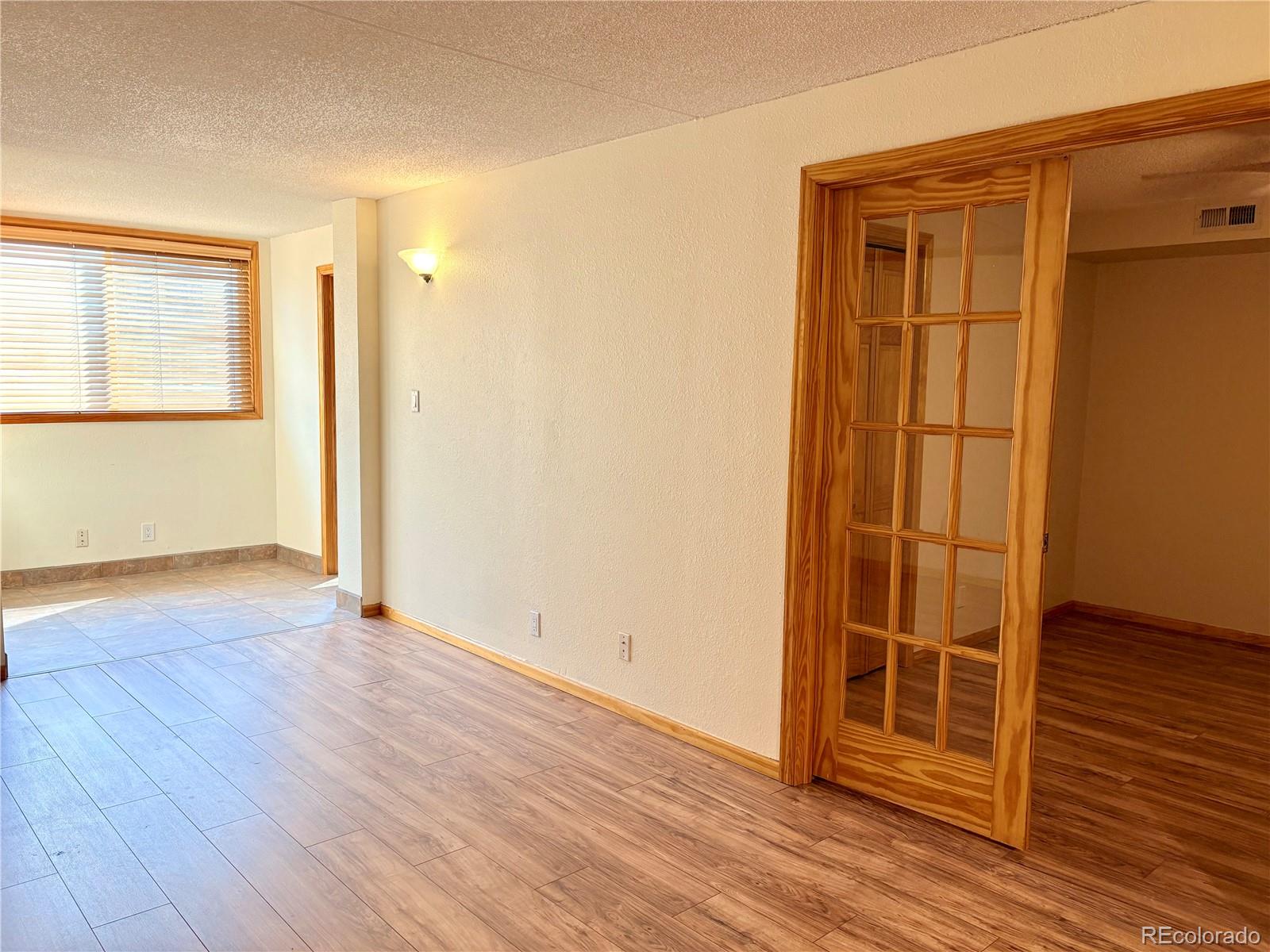805 29th Street, Unit 253 Boulder, CO 80303 - Photo 14 of 32 an empty room with wooden floor and windows