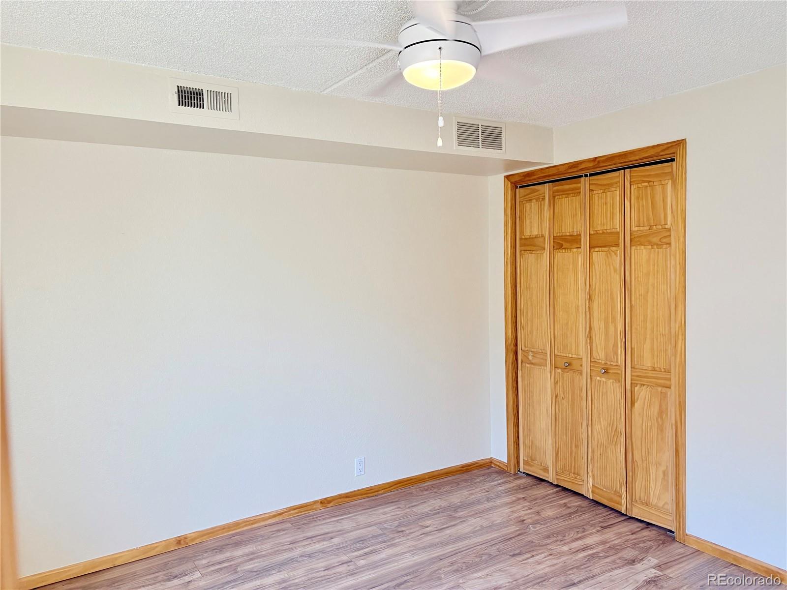 805 29th Street, Unit 253 Boulder, CO 80303 - Photo 17 of 32 a view of an empty room with wooden floor and a window