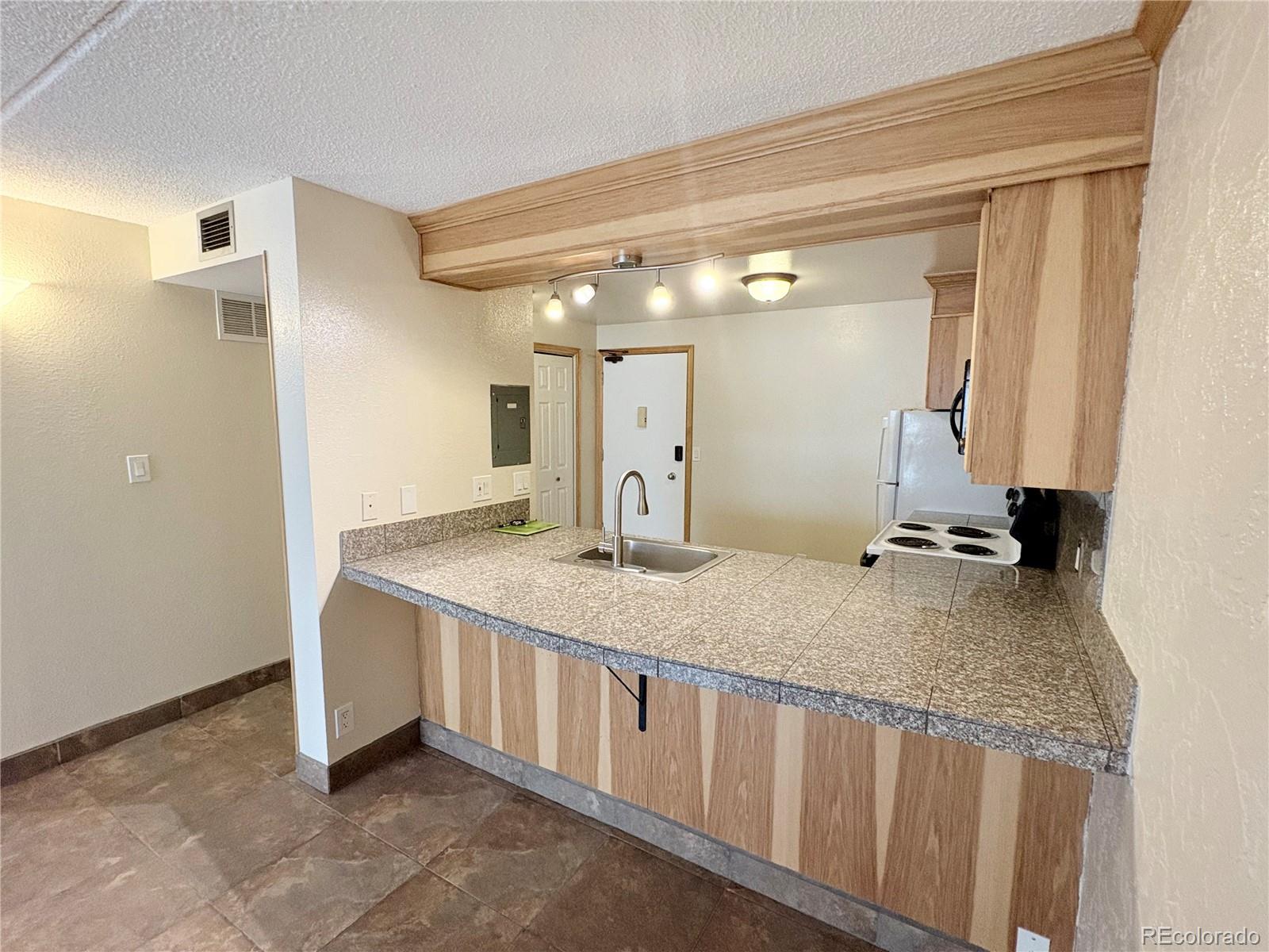 805 29th Street, Unit 253 Boulder, CO 80303 - Photo 20 of 32 a bathroom with a granite countertop sink and a mirror