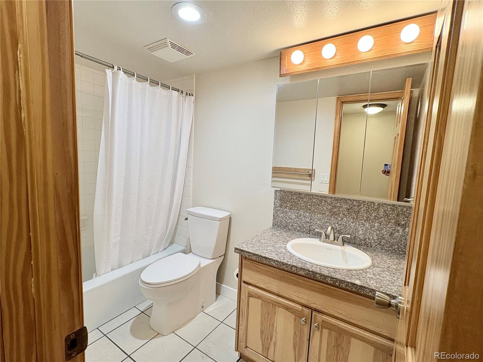 805 29th Street, Unit 253 Boulder, CO 80303 - Photo 22 of 32 a bathroom with a sink a toilet a mirror and shower