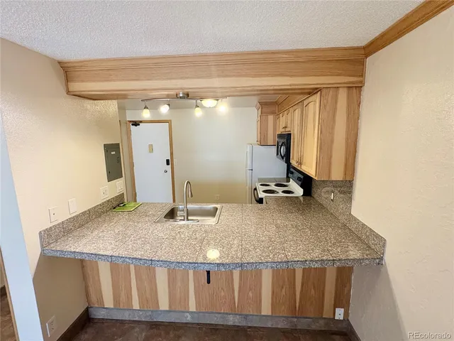 a view of a room with wooden floor and a window