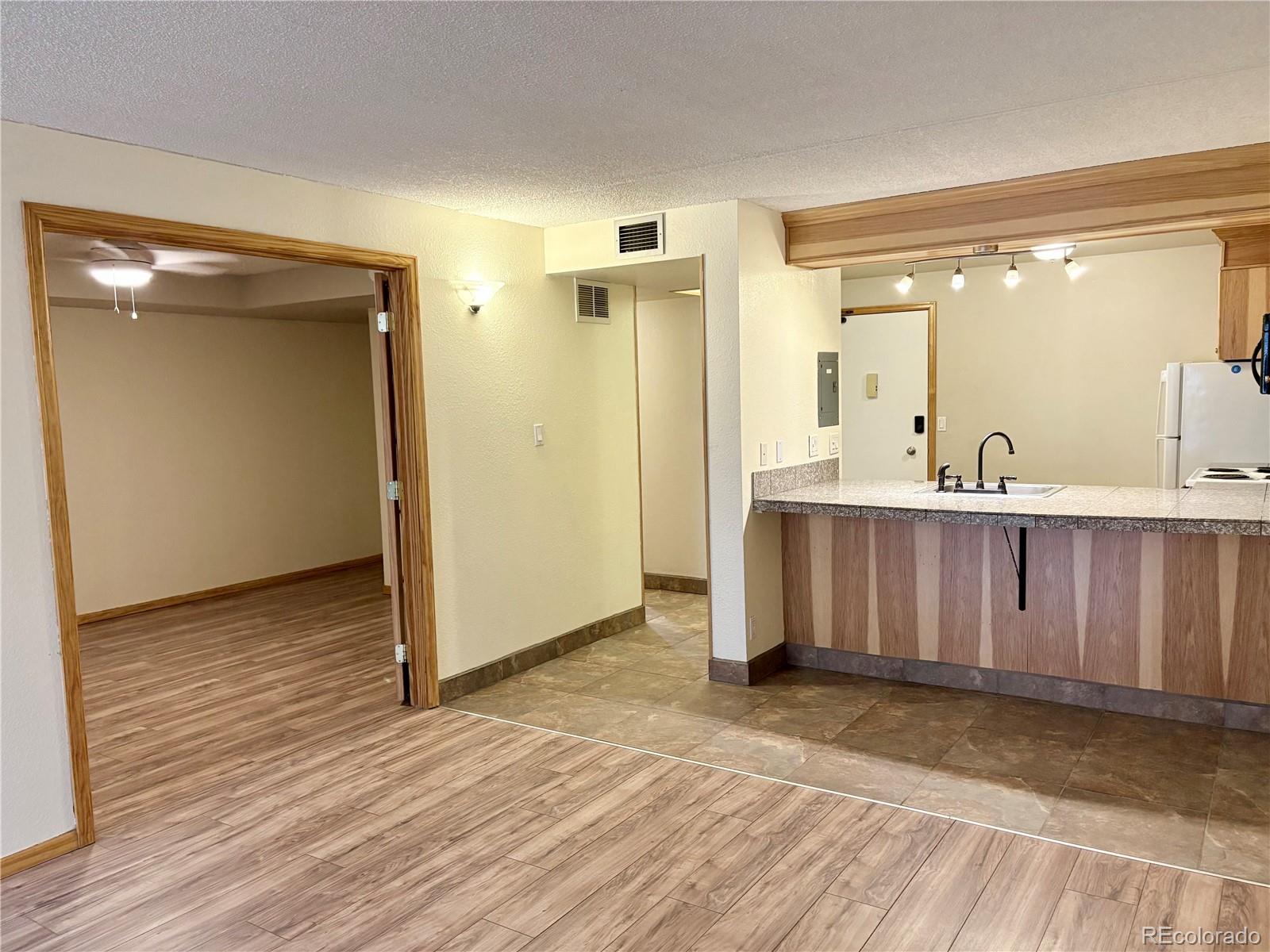 805 29th Street, Unit 253 Boulder, CO 80303 - Photo 6 of 32 a view of a hallway with wooden floor and a sink