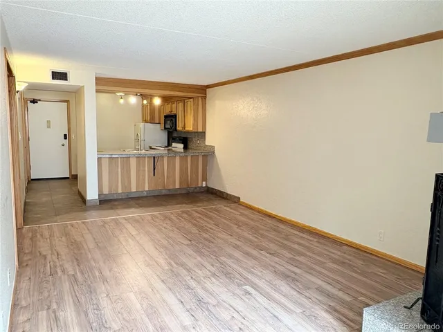 an empty room with wooden floor and a window