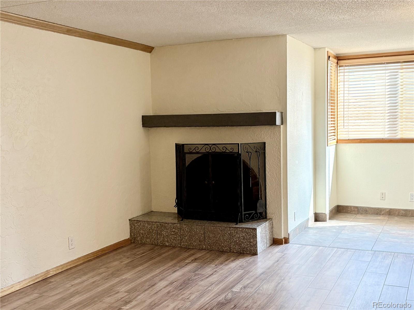 805 29th Street, Unit 253 Boulder, CO 80303 - Photo 8 of 32 a living room with a fireplace and a wooden floor