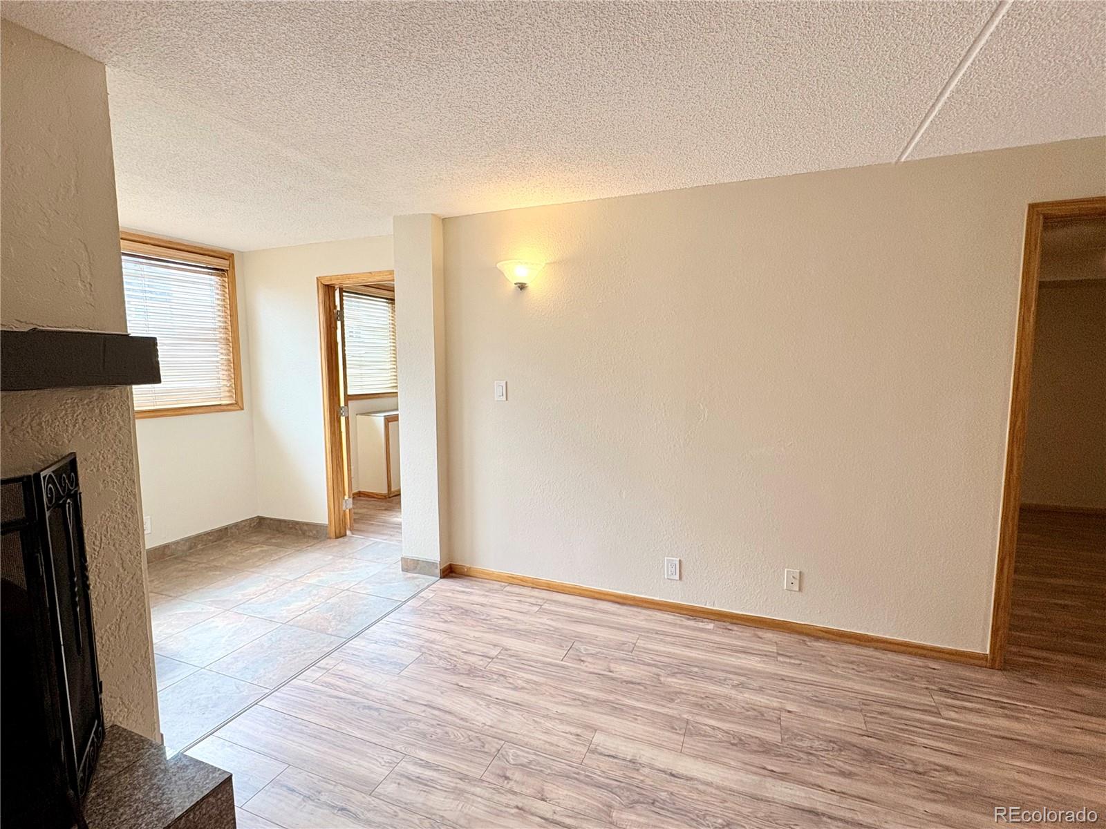 805 29th Street, Unit 253 Boulder, CO 80303 - Photo 9 of 32 an empty room with wooden floor and a window