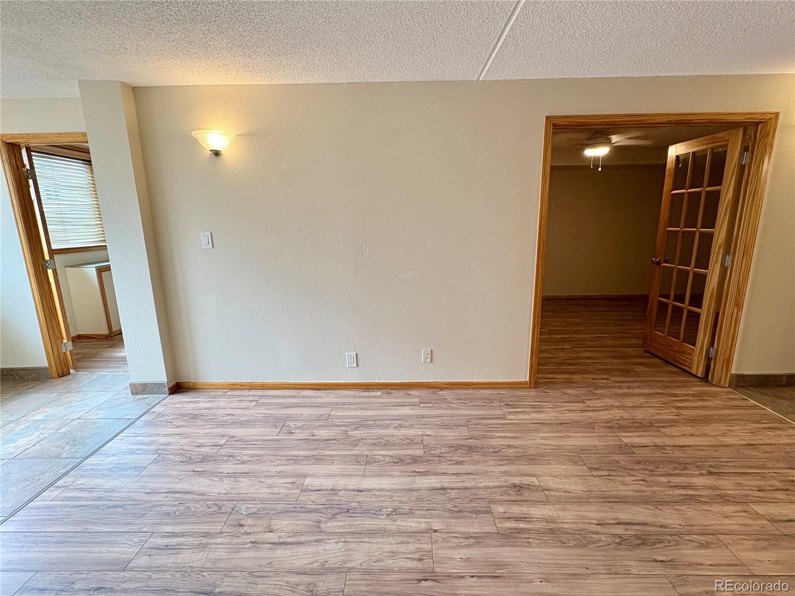 805 29th Street, Unit 253 Boulder, CO 80303 - Photo 10 of 32 a view of an empty room with wooden floor and stairs