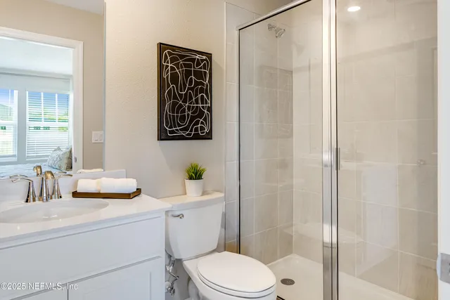 a bathroom with a toilet sink and shower
