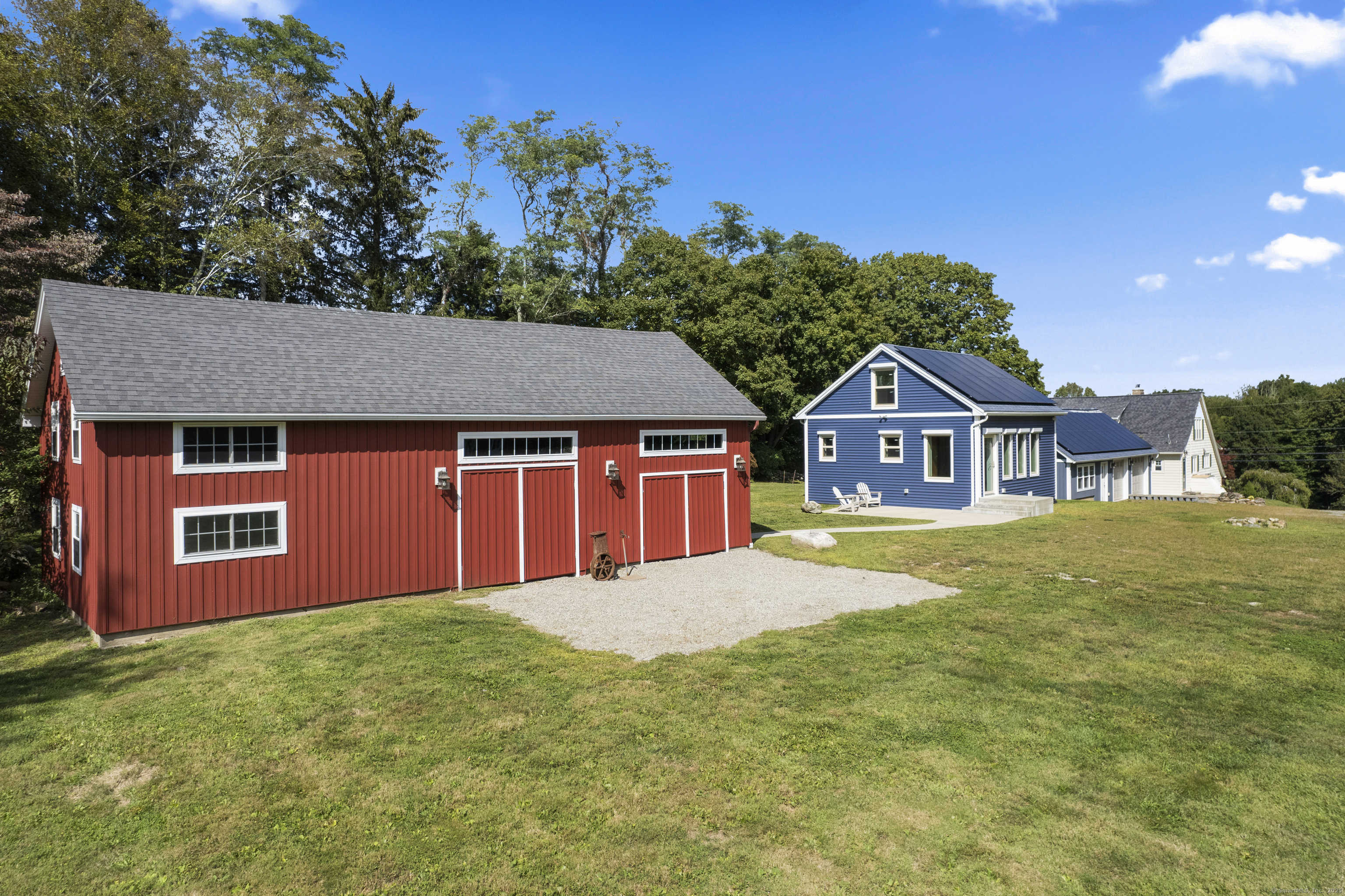 587 Taugwonk Road Stonington, CT 06378 - Photo 11 of 38 a front view of a house with a yard and garage