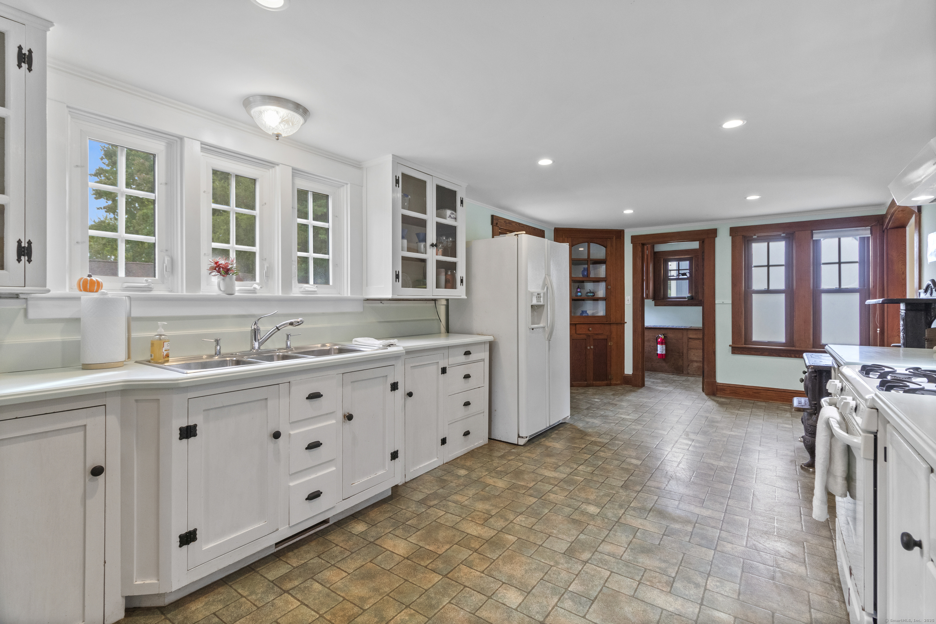 587 Taugwonk Road Stonington, CT 06378 - Photo 17 of 38 a spacious bathroom with a double vanity sink a two mirror and a bathtub