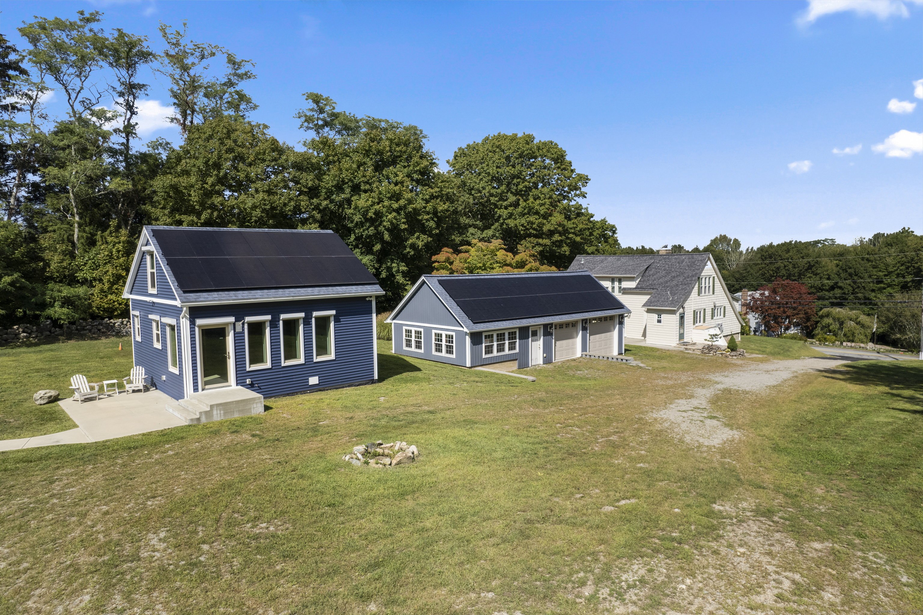 587 Taugwonk Road Stonington, CT 06378 - Photo 8 of 38 a front view of a house with a yard