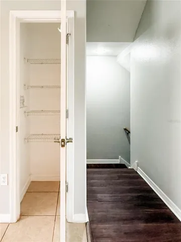 a room with wooden floor and windows