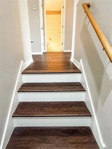 a large bathroom with a large tub shower and checkered floor