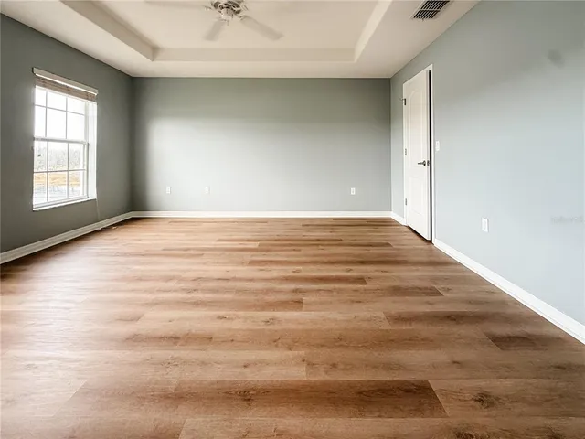 a spacious bathroom with a granite countertop sink a mirror and shower