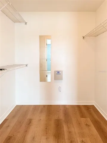 an empty room with wooden floor and closet