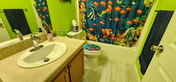 a bathroom with a sink mirror and vanity