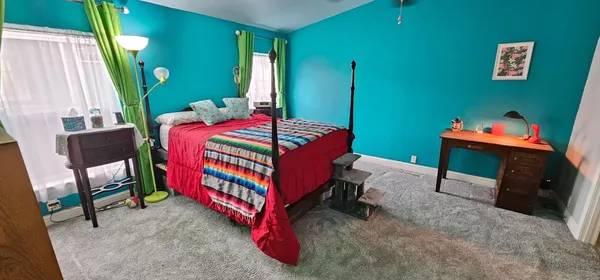a bedroom with a bed and a window