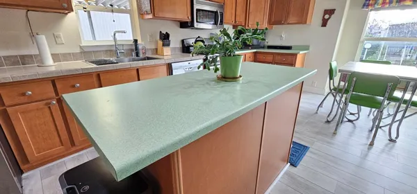 a view of kitchen with granite countertop window dining table and chairs
