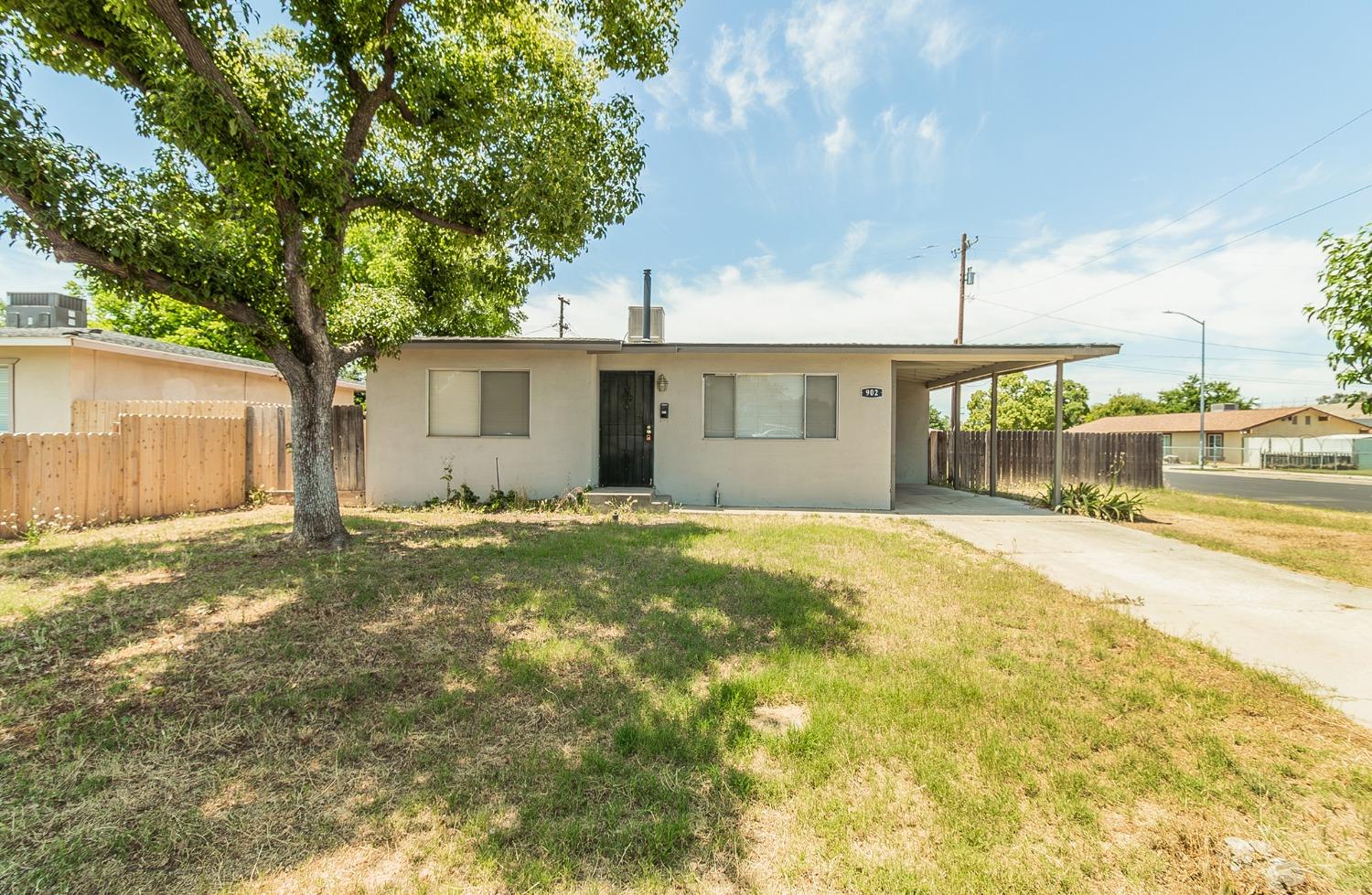 902 Music Avenue Clovis, CA 93612 - Photo 1 of 21 a view of a house with a backyard and a tree