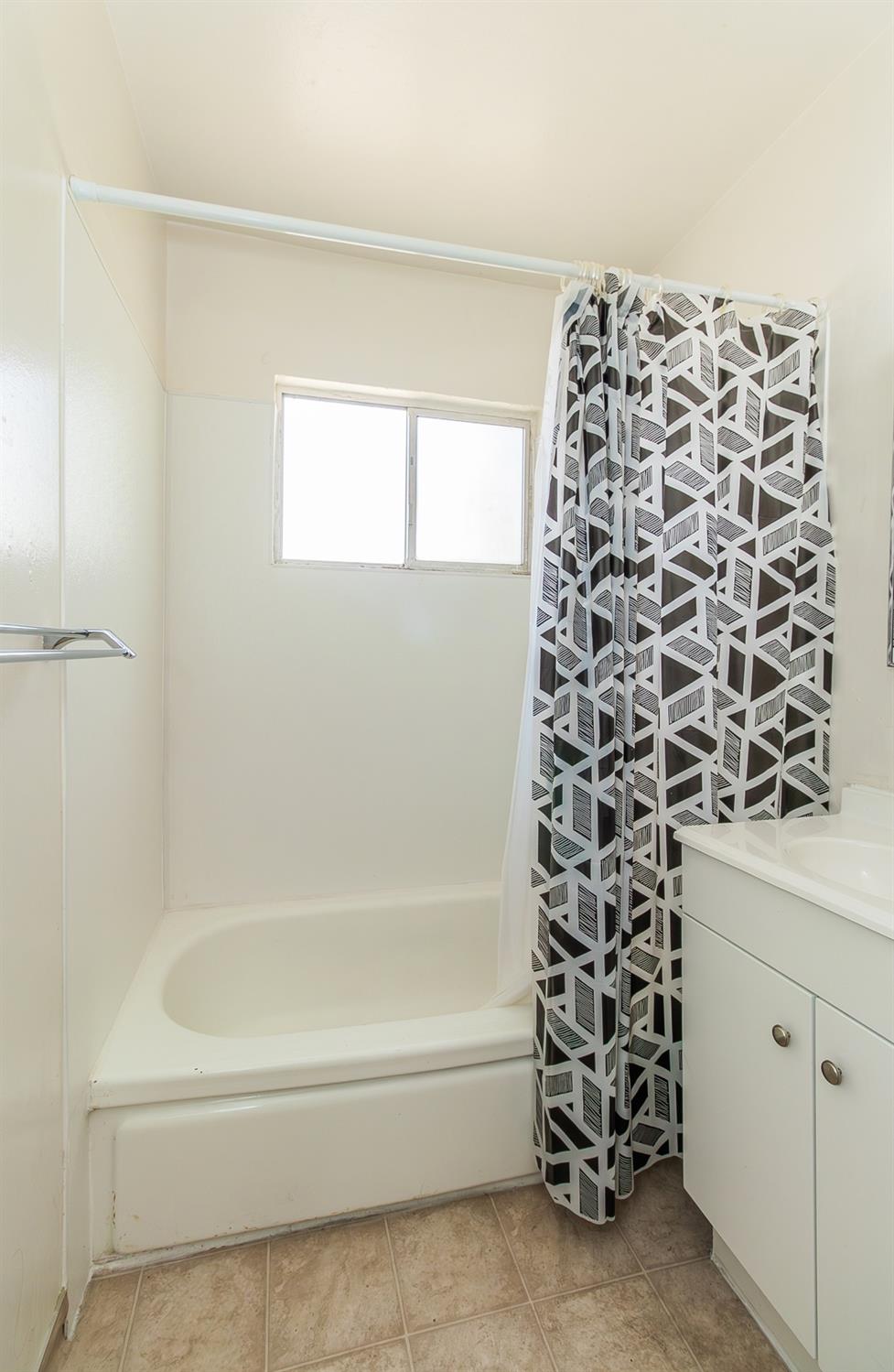 902 Music Avenue Clovis, CA 93612 - Photo 11 of 21 a bathroom with a bathtub and shower