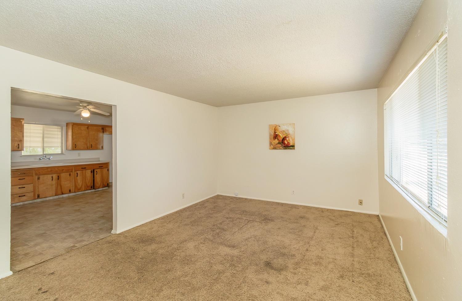 902 Music Avenue Clovis, CA 93612 - Photo 3 of 21 an empty room with a white wall and natural light