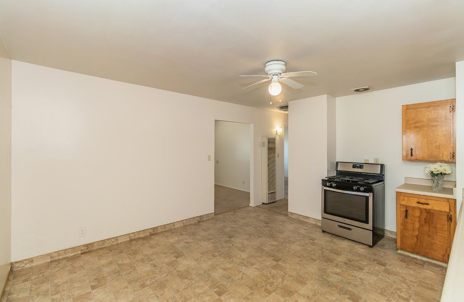 902 Music Avenue Clovis, CA 93612 - Photo 7 of 21 a view of a kitchen with a sink a refrigerator and cabinets