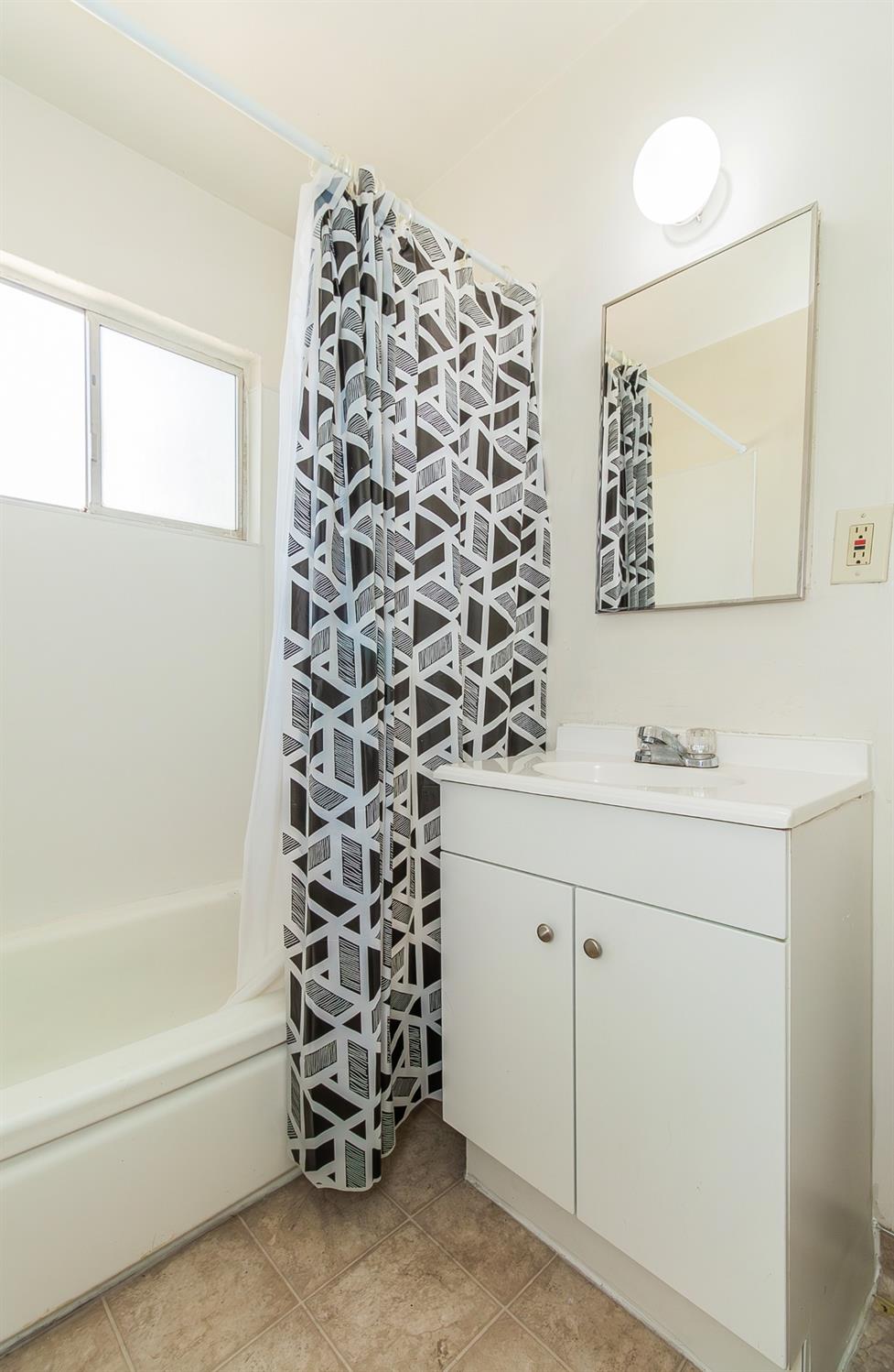 902 Music Avenue Clovis, CA 93612 - Photo 10 of 21 a bathroom with a bathtub sink and mirror