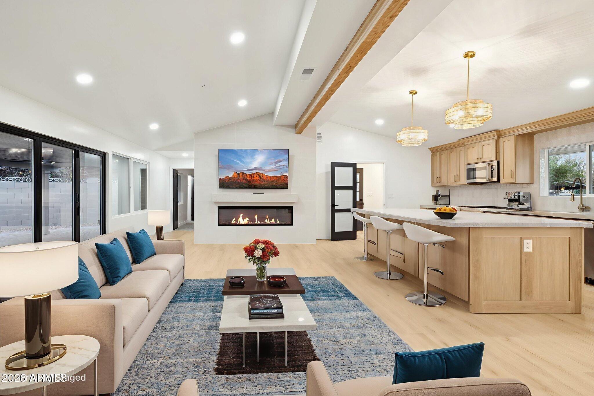 1216 West Rovey Avenue Phoenix, AZ 85013 - Photo 12 of 45 a living room with furniture a rug kitchen view and a large window