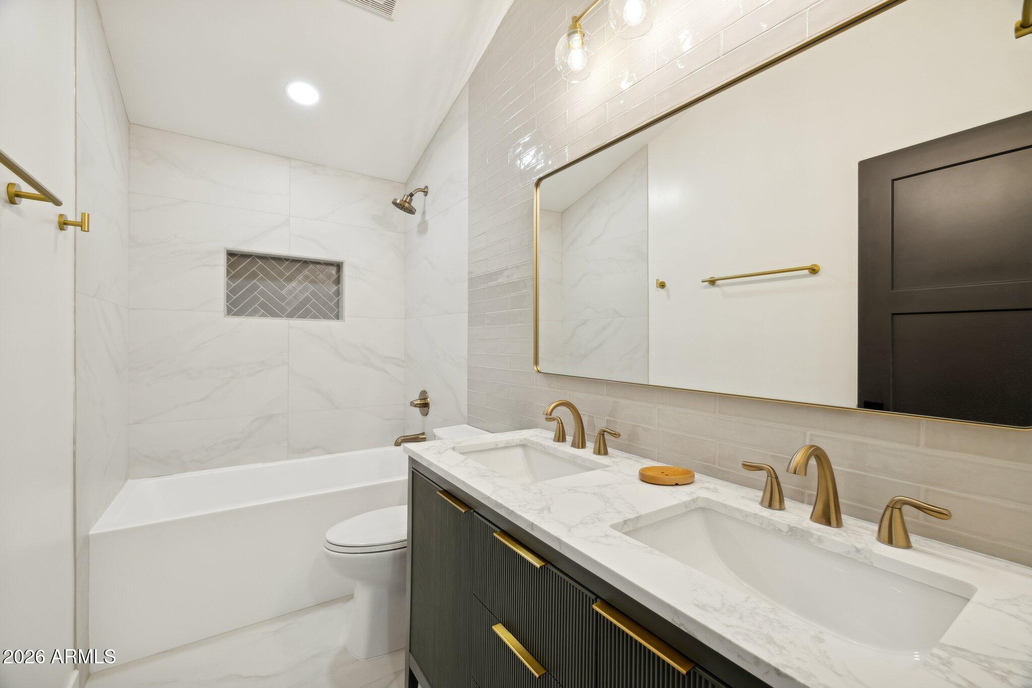 1216 West Rovey Avenue Phoenix, AZ 85013 - Photo 25 of 45 a bathroom with a granite countertop sink a toilet and shower