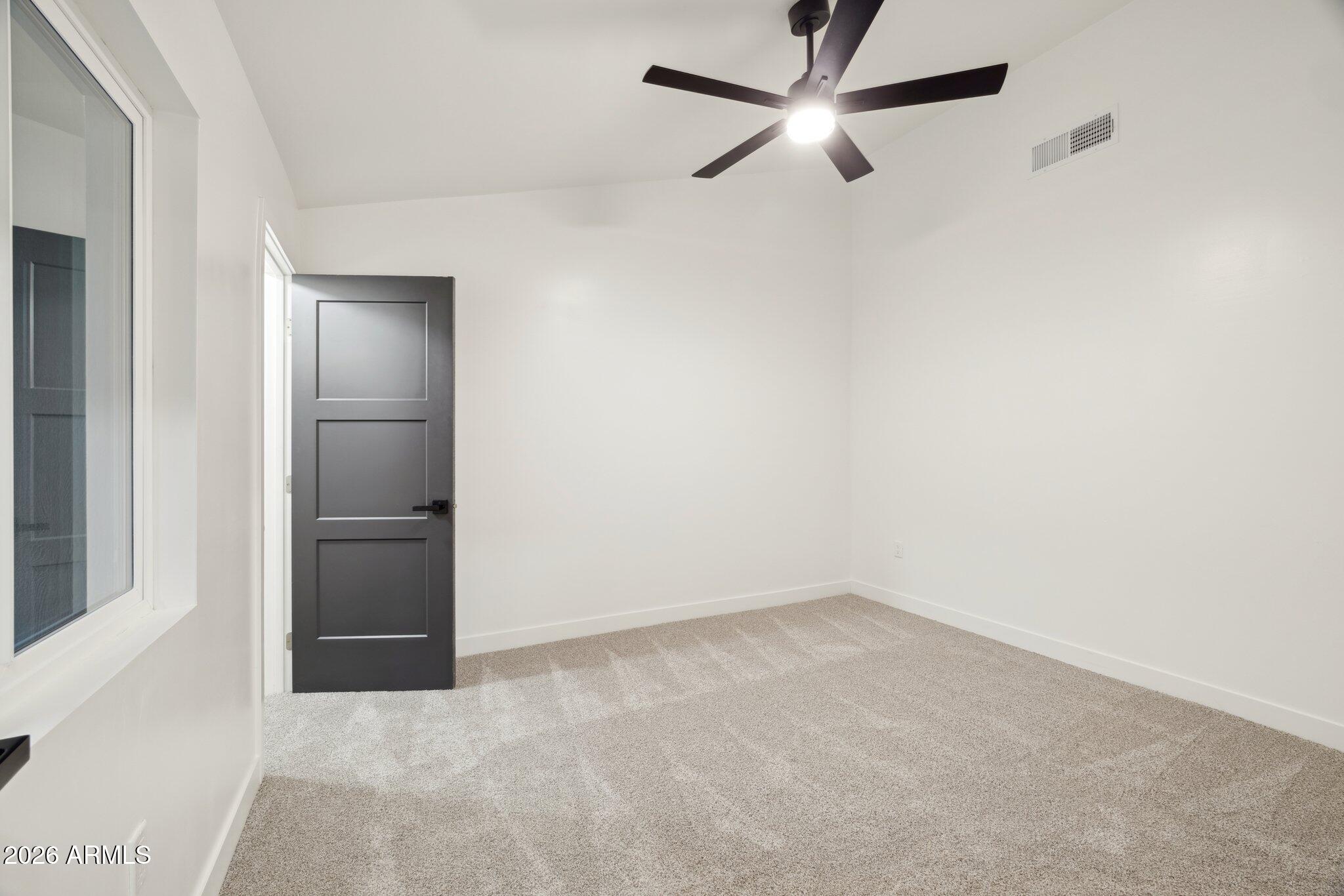 1216 West Rovey Avenue Phoenix, AZ 85013 - Photo 28 of 45 an empty room with closet and ceiling fan