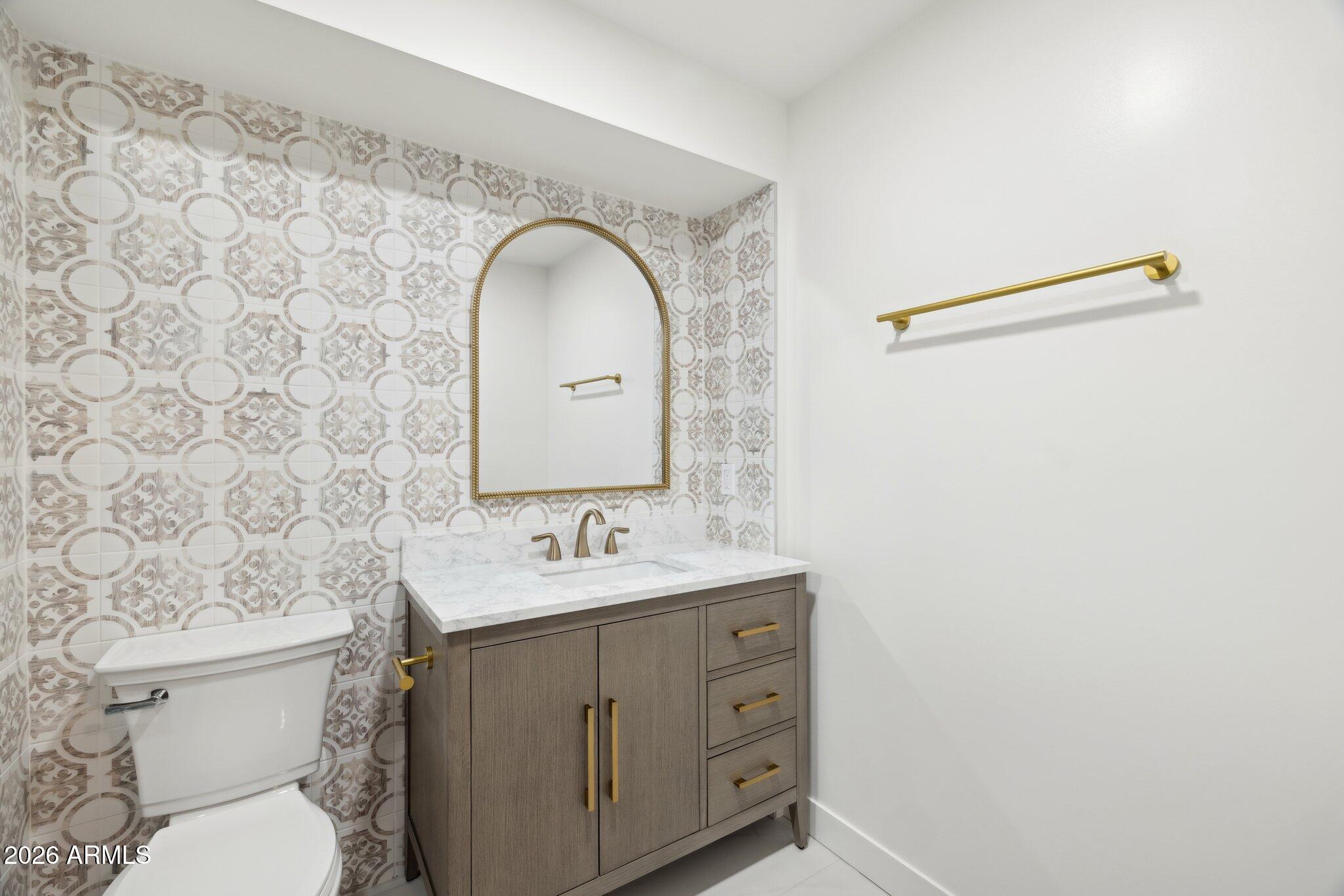 1216 West Rovey Avenue Phoenix, AZ 85013 - Photo 30 of 45 a bathroom with a toilet sink and mirror